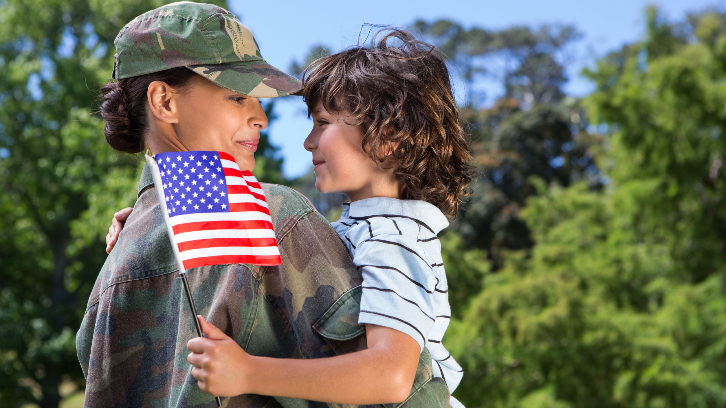 Woman soldier reunited with her son on a sunny day