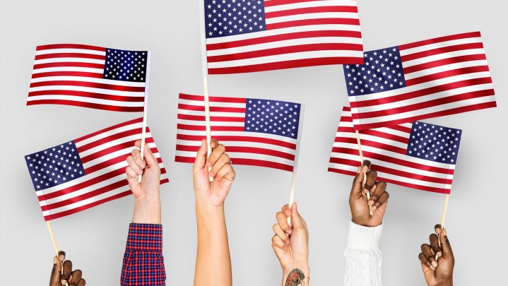 Hands holding small flags