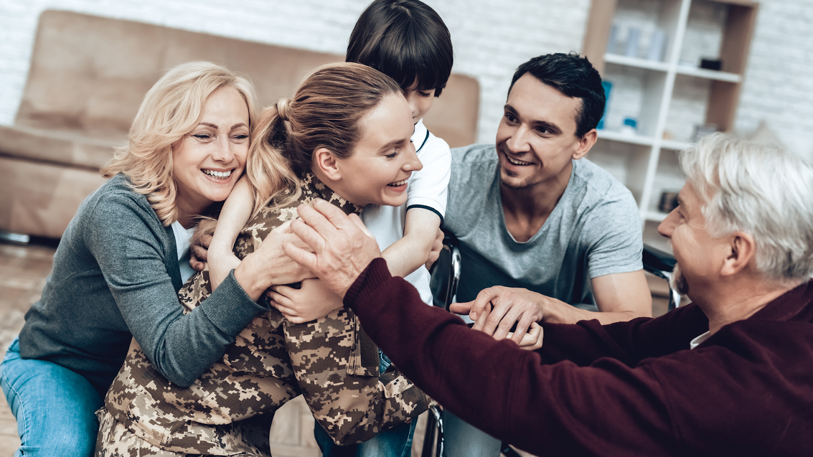 Military mom hugging family